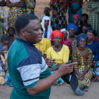 African man talking to a group of people African man talking to a group of people
